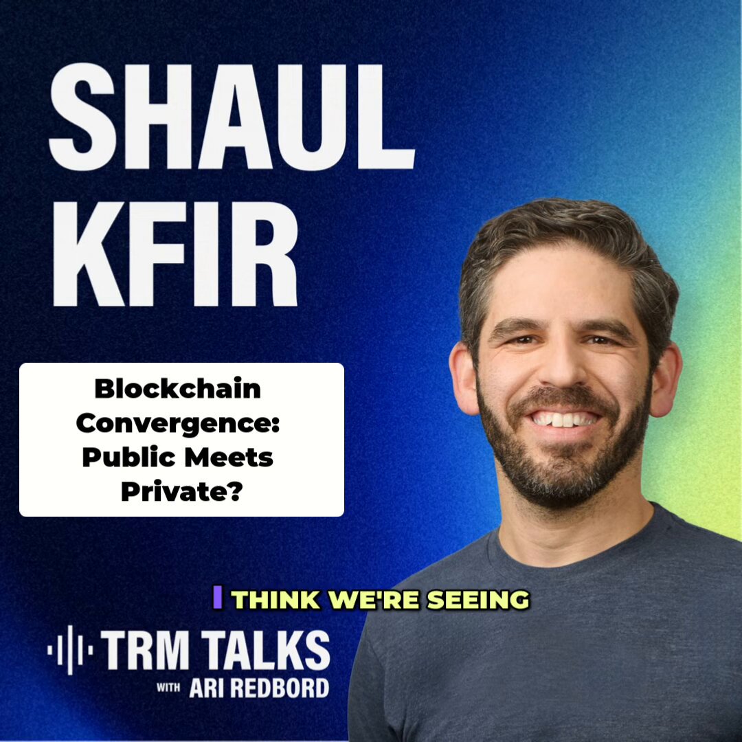The image features a man wearing a blue shirt smiling at the camera while reading from a poster or book titled "Public and private blockchain were never opposites". The poster also includes text that reads, "I think we're seeing" and "@ARedbord with @ShaulKfir discussing with @Public and private blockchain.".