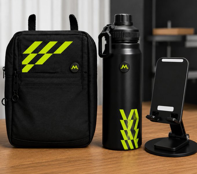 Product photo displaying a black backpack, black water bottle, and phone stand, all featuring neon green 'MW' branding on a wooden surface.