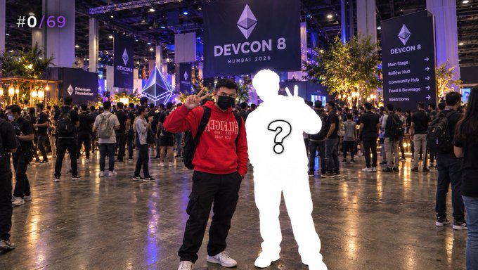 A person wearing a red 'BURBERRY' hoodie and black mask poses at the Devcon 8 Mumbai 2026 blockchain conference, standing next to a white silhouette figure with a question mark, with the text '#0/69' in the corner.
