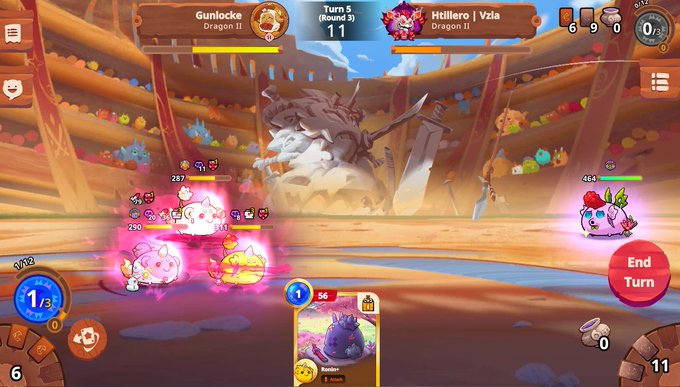 A screenshot of a mobile turn-based battle game called 'Dragon Ball' where player 'Gunlocke' (Dragon II) is facing 'Htillero | Vzla' (Dragon II) in 'Turn 5 (Round 3)' in an arena with cute creature characters and a large beast in the background.