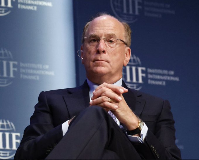 A distinguished older man in a dark suit and glasses sits with his hands clasped at the Institute of International Finance (IIF), where the "IIF" logo is repeated across the blue backdrop. The image visually lends authority to claims about major financial institutions making significant Bitcoin purchases, lending a serious atmosphere to the dramatic market announcement.
