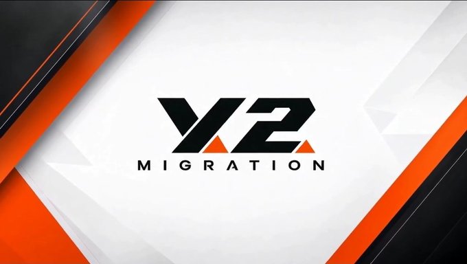 The image displays a stylized logo reading "V/2 MIGRATION" in bold black and orange text against a white geometric background framed by diagonal orange and dark gray panels. The graphic visually reinforces the post's announcement that the V2 migration process is wrapping up, serving as a branded header for the XAX Trading update.