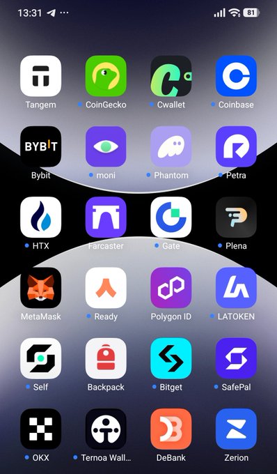 A smartphone home screen displaying various crypto and finance app icons including Tangem, CoinGecko, Cwallet, Coinbase, Bybit, MetaMask, and others.
