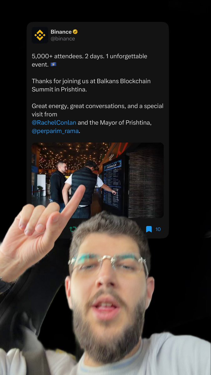 The image features a man with glasses, wearing a white shirt, giving a thumbs up gesture towards his phone screen. The background of the image is black, making the white text on the phone stand out prominently. The caption below the image reads "Over 5000 attendees and amazing vibess thank you @binance".