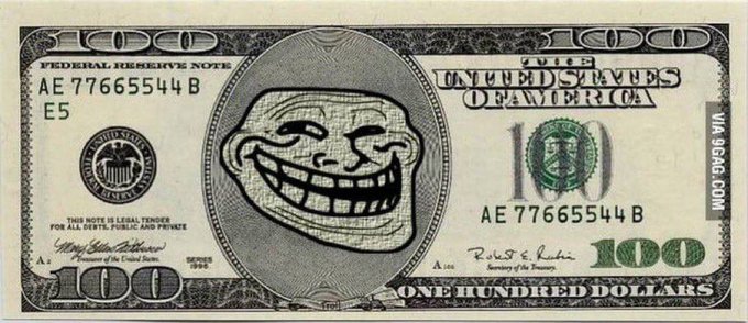 A modified US $100 bill with a troll face meme superimposed on the portrait area, watermarked 'VIA 9GAG.COM'.