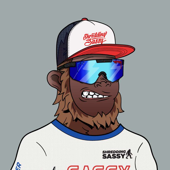 A cartoon character labeled 'Shredding Sassy' wearing a trucker hat, blue reflective sunglasses, and a white jersey, with a Sasquatch logo on the chest.
