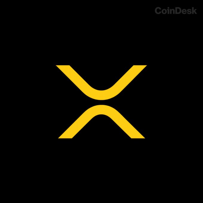 The image displays the yellow XRP cryptocurrency logo on a black background with a "CoinDesk" watermark in the upper right corner, visually representing the XRP token referenced in the post about its price falling below $1.