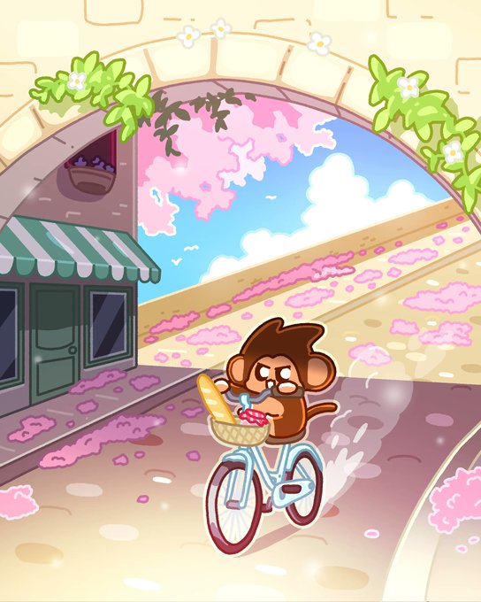 An animated illustration shows a cartoon monkey riding a bicycle with a basket full of bread through a sunny village street framed by a stone archway and pink flowers.