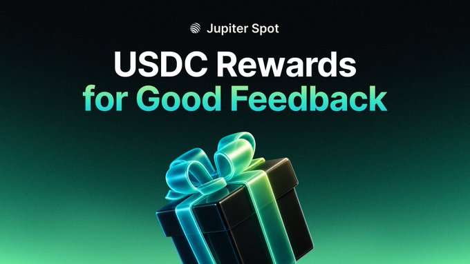 A promotional graphic for 'Jupiter Spot' offering 'USDC Rewards for Good Feedback', featuring a 3D-rendered black gift box with a glowing teal and green ribbon on a dark green background.