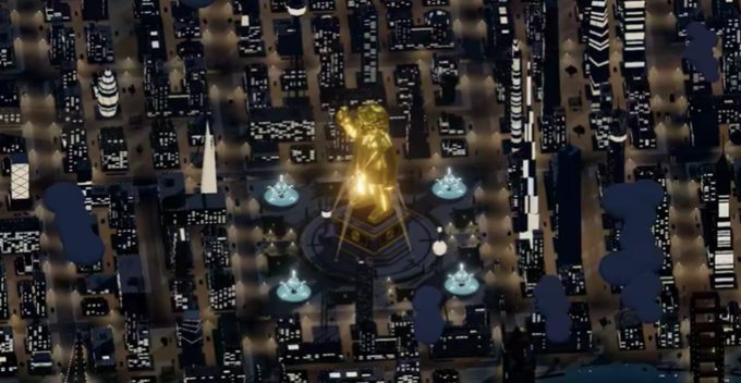 An aerial nighttime view shows a dense city grid surrounding a brightly lit central monument and circular plaza.