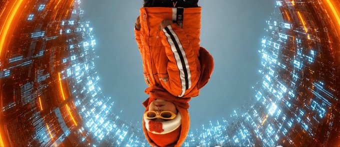 "The Memory Economy" is a movie that features an orange-jacketed person standing inside a circular tunnel, which appears to be made of glass or light blue material. The scene takes place during nighttime with bright lights surrounding the tunnel. The image also contains text that reads "focus on what is in the image and how it relates to the post". This could possibly be an advertisement for the movie or a promotional message related to the film's content.