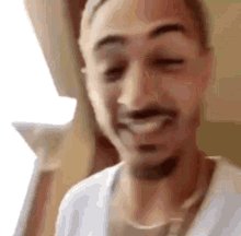 The image shows a man with a beard wearing a white shirt, making a funny or silly face for the camera. The caption below the photo reads "hands up if you decided to stack sol/eth on the last couple of dips instead of hype (hands up)". This suggests that the man is intentionally making a humorous or cheeky expression in response to an image of himself with his hands raised, possibly as part of a joke or playful challenge.