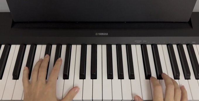 A pair of hands plays a black Yamaha digital piano, with the brand name "YAMAHA" clearly visible on the back panel above the keys. The image complements the post's theme of musicians seeking new platforms to share their music and NFTs in the web3 space.
