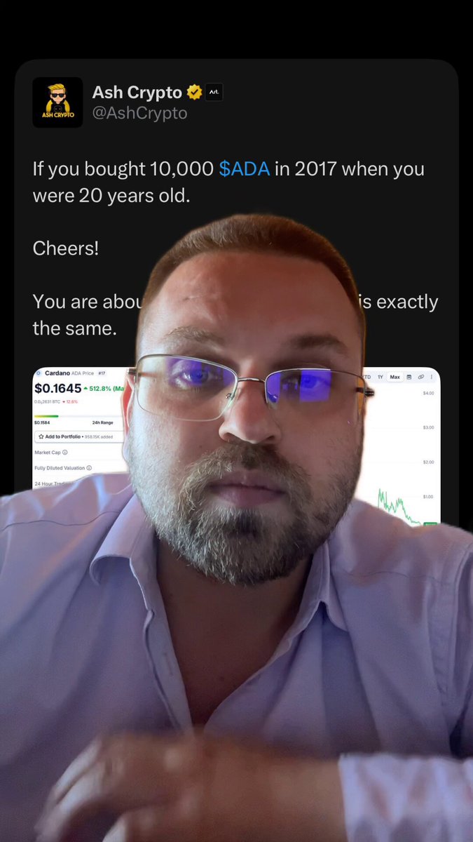 The image features a man wearing glasses, sitting at a table with his hands resting on it. He appears to be looking down or thinking about something. The background of the image shows a computer screen displaying some text related to cryptocurrency trading.