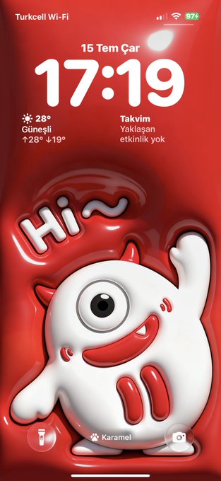 An iPhone lock screen displays a red wallpaper featuring a cute 3D white bull character with a small horn, waving hello with rosy cheeks and a happy smile above the word "Hi~", while the time reads "17:19" on Wednesday, July 15 (15 Tem Çar) with 28° weather and a 97% battery shown at the top.