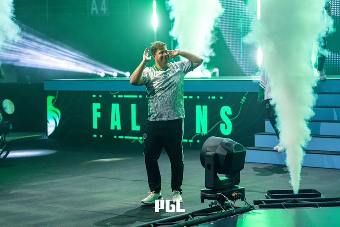A player in a white and green Falcons jersey stands center stage with hands cupped around his mouth, performing an entrance with dramatic green lighting, smoke machines, and "FALCONS" branding behind him at what appears to be a PGL esports tournament. The accompanying post refers to the Falcons player "Anubis," suggesting the image depicts this player during a high-stakes match moment, with traders doubting a potential comeback.