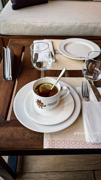 The image features a wooden table with various items placed on top of it. There are two cups - one containing tea or coffee and another empty. A spoon rests near the cup, possibly used for stirring the beverage. The table also has plates, forks, and knives arranged neatly around them. The post about GM gTRIA cards is interesting because they offer a simple yet secure way to store digital currency without needing an internet connection. This makes it convenient for everyday use while still maintaining a sense of self-custody over one's funds.