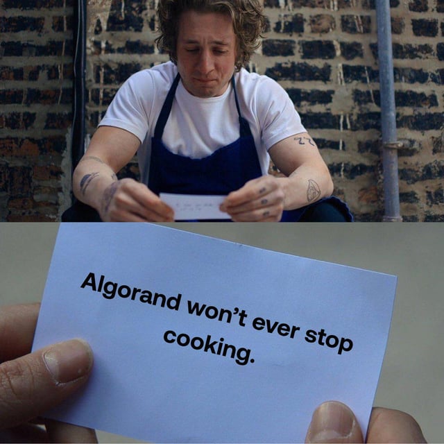 The image shows a person holding up a piece of paper with text written on it, which reads "Algorithand won't ever stop cooking." The person's hands are visible as they hold the paper against a brick wall backdrop.