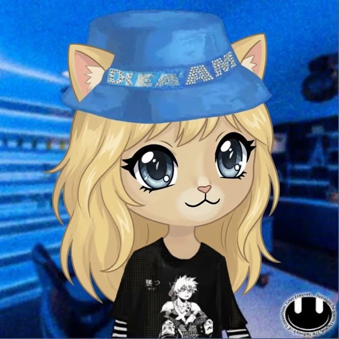 A cartoon avatar of a blonde cat-girl with large blue eyes wearing a blue bucket hat that reads 'DREAMER' in rhinestones and a black t-shirt with anime characters, against a blue-lit background.
