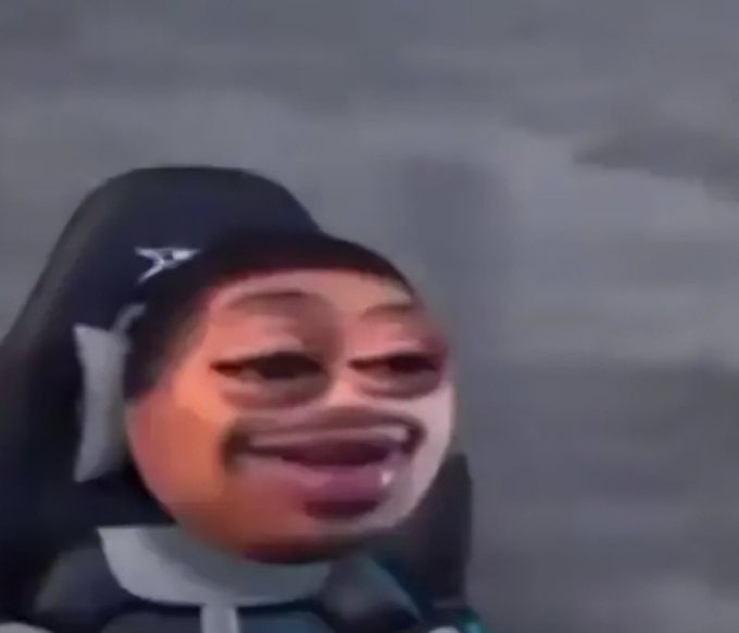 A distorted, low-quality meme image showing a person in a gaming chair with an exaggerated, laughing face superimposed over their features.