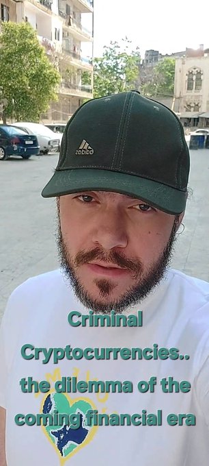 A selfie of a bearded man wearing a green Adidas cap and white t-shirt, with overlaid text reading 'Criminal Cryptocurrencies.. the dilemma of the coming financial era'.