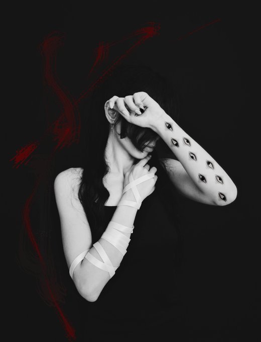 A striking black and white photograph shows a figure with long dark hair, hands raised to their face, wearing bandages wrapped around one arm and a forearm adorned with a pattern of eyes, set against a black background with dramatic red brushstrokes. The haunting, surreal imagery evokes a sense of silent introspection, fitting for an art piece titled "Whisper of silence."