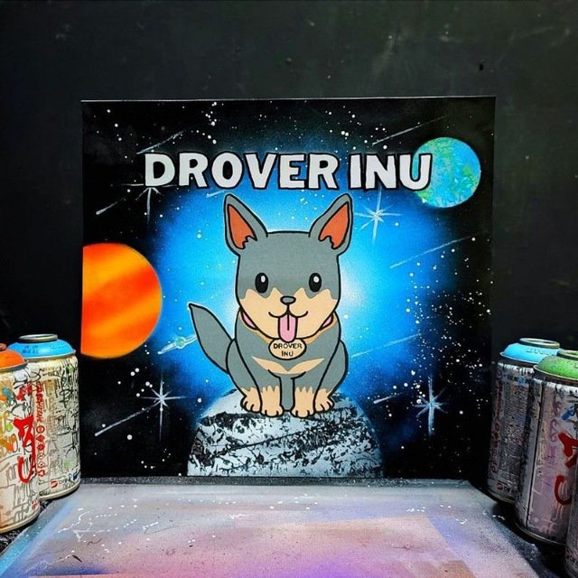A cartoon-style painting of a Shiba Inu dog sitting on a moon with its tongue out wearing a 'DROVER INU' tag, set against a starry space background with planets, titled 'DROVER INU', flanked by spray paint cans.
