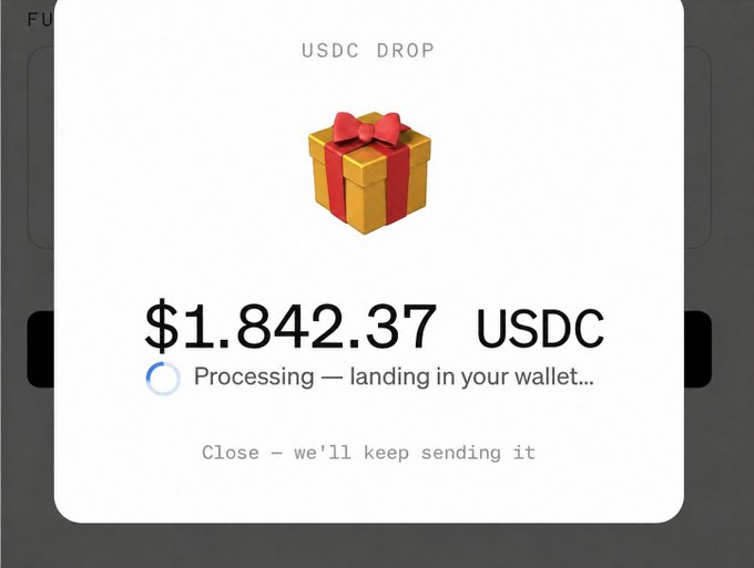 A digital notification showing a USDC Drop gift box with the amount $1,842.37 USDC, indicating 'Processing — landing in your wallet...' with an option to close.