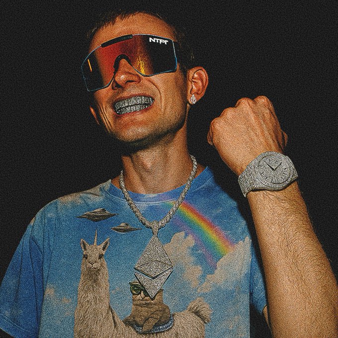 A man wearing reflective sunglasses labeled "NTF," grills, a diamond-encrusted watch, and a chain with an Ethereum pendant, dressed in a llama-themed t-shirt.