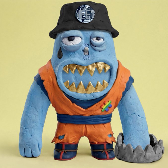 A clay sculpture of a blue monster wearing a black "NEET" bucket hat and an orange gi, with an ON/OFF switch on its face and gold teeth.