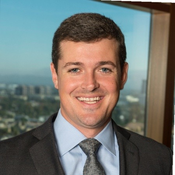 A professional headshot of Marc Boiron, CEO of Polygon Labs, is shown. He is smiling at the camera, wearing a suit and tie, with a cityscape visible in the background.