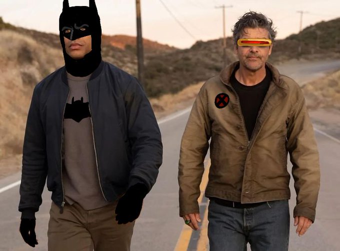 A person dressed as Batman alongside a man wearing a Cyclops-style visor and an X-Men jacket, standing on a desolate desert road, visually parodying superhero team-ups in response to the question about the 2026 film "MENTHOR."