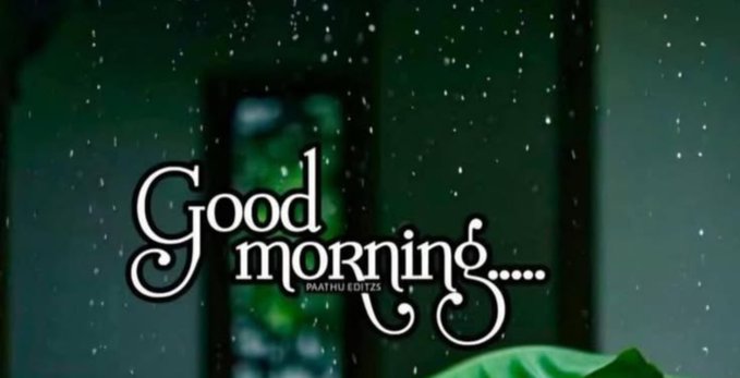 A 'Good morning....' greeting card or wallpaper with decorative white text overlaid on a blurred background showing a window with falling snow or rain.