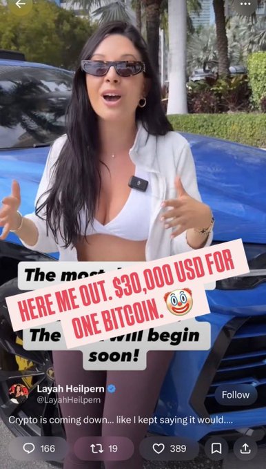 A tweet from Layah Heilpern (@LayahHeilpern) overlaid on a video of a woman in sunglasses speaking, with text reading 'The most paranoid will begin...' and a sticker saying 'HERE ME OUT. $30,000 USD FOR ONE BITCOIN.'