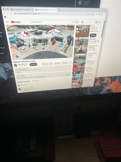 A computer monitor displays a YouTube video titled 'Betting $1,000,000 per Hand...' by SteveWillDoIt, showing an aerial view of a property decorated with Kansas City Chiefs and Denver Broncos logos.