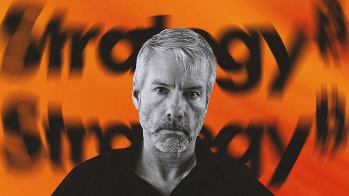 A black-and-white photo of Michael Saylor staring intensely at the camera is set against a vivid orange background featuring the word "Strategy" repeated in a blurred, stamp-like pattern.

The image ties into the post by visually representing Saylor as the strategist behind the cash reserve buildup, with the "Strategy" wordplay reinforcing both his company name and his bullish approach to amassing capital and Bitcoin.