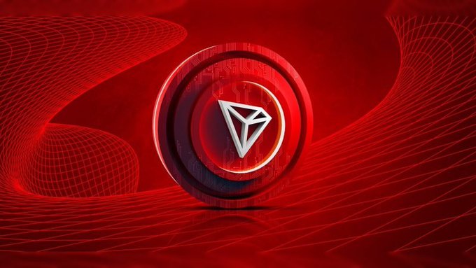 A 3D rendering of a TRON cryptocurrency coin with a diamond-shaped logo, set against a flowing red background with circuit patterns.