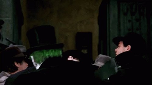 The image shows three people sitting together with one person wearing a top hat, while another person has a black coat. The third person appears to be looking at something or someone outside of the frame. The caption reads "No one saw Canton coming. And if we’re being honest, not many saw Stellar being the second major announcement by the DTCC". This suggests that there might have been an unexpected event or news related to a popular TV show or movie involving the character Canton.