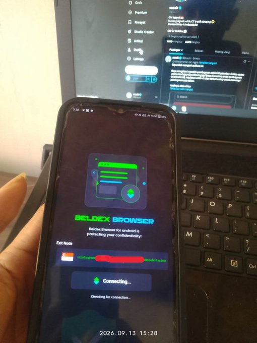 A person holds a smartphone displaying the 'BELDEX BROWSER' app with 'Exit Node' settings visible, while a laptop screen showing various apps sits in the background.