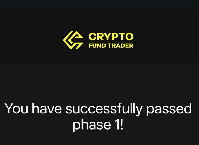 A black screen with the yellow 'CRYPTO FUND TRADER' logo and white text reading 'You have successfully passed phase 1!'.