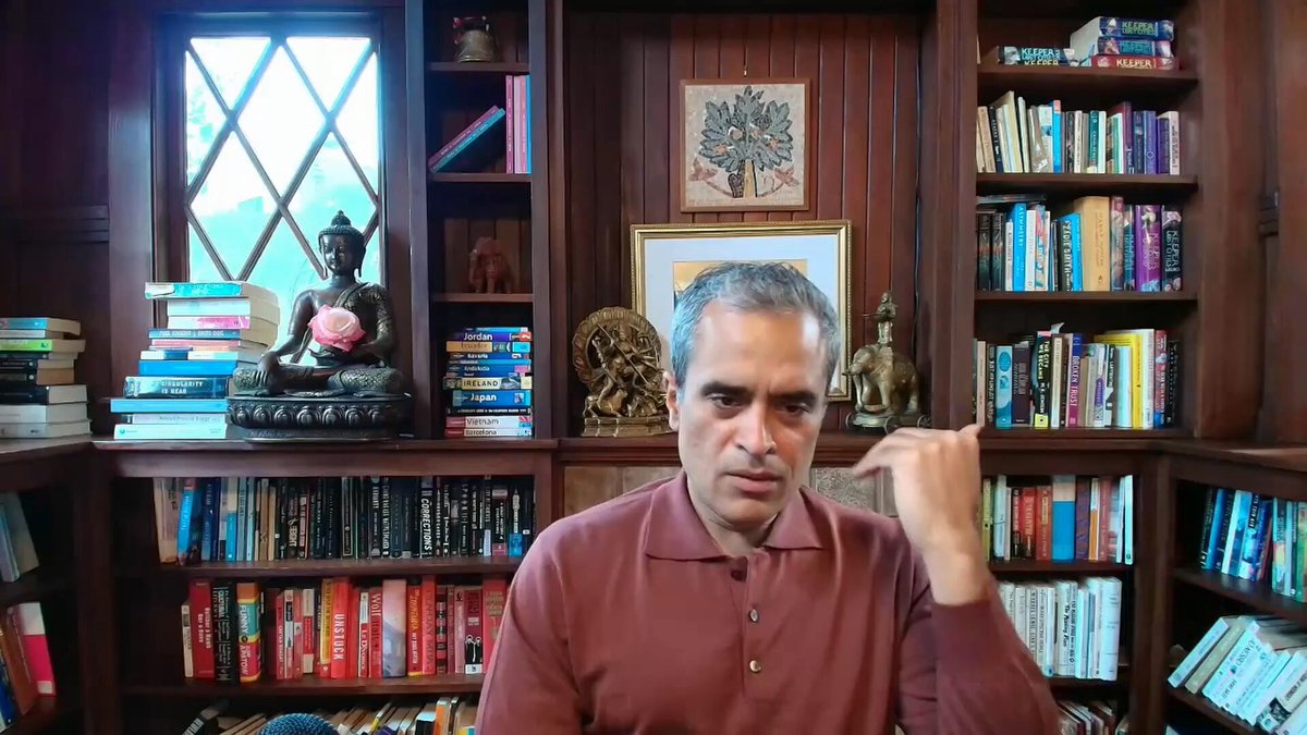 The image shows a man sitting at a desk surrounded by numerous books, suggesting he might be an avid reader or involved in some form of academic work. The man appears to be making a hand gesture while seated in front of a computer screen, which could indicate that he is engaged in online learning or research. The post also mentions the evolution of the internet and how ads were once the dominant business model for online services. This implies that the image might have been taken during the early days of the internet when advertising was prevalent as an alternative source of revenue for online content creators, such as blogs and forums.