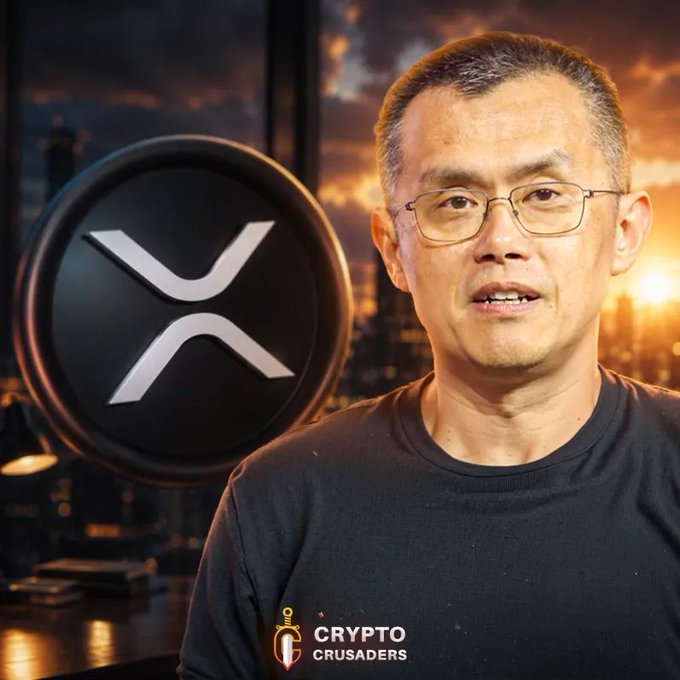 The image features a man wearing glasses, standing next to a computer monitor with an XR coin logo displayed behind him. The background of the image shows a city skyline at sunset, creating a serene atmosphere. The text "Binance Founder CZ says countries need to tokenize stocks and issue their own crypto stablecoins to allow worldwide buyers" suggests that the man might be discussing the potential benefits or challenges related to cryptocurrency adoption in different countries.