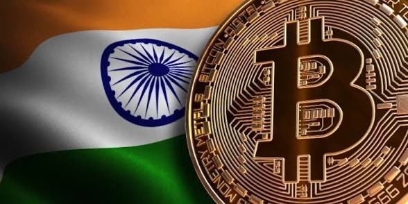 A golden Bitcoin coin rests against the backdrop of the Indian flag, with the text "BITCOIN DIGITAL DECENTRALIZED PEER TO PEER" visible on its edge, symbolizing the intersection of cryptocurrency and India's evolving regulatory stance as lawmakers consider enhanced crypto monitoring measures.