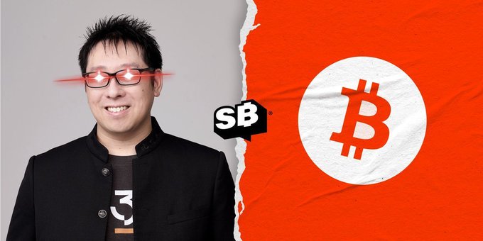 The image features a man with red glasses standing next to an advertisement that includes a red Bitcoin symbol and the text "SBB" above him. The text reads "SAMSON MOW: 'Bitcoin is permissionless, decentralized, neutral money for US, NOT for the people wearing orange ties, ETFs, or nation-states!'" This message seems to be promoting Bitcoin as a form of currency that can be used by anyone without any restrictions.

The man with red glasses appears to be smiling and posing in front of the advertisement, which adds a sense of positivity and excitement about the concept of Bitcoin. The combination of the man's facial expression and the Bitcoin symbol creates an interesting visual contrast between the real-life person and the digital currency being promoted.
