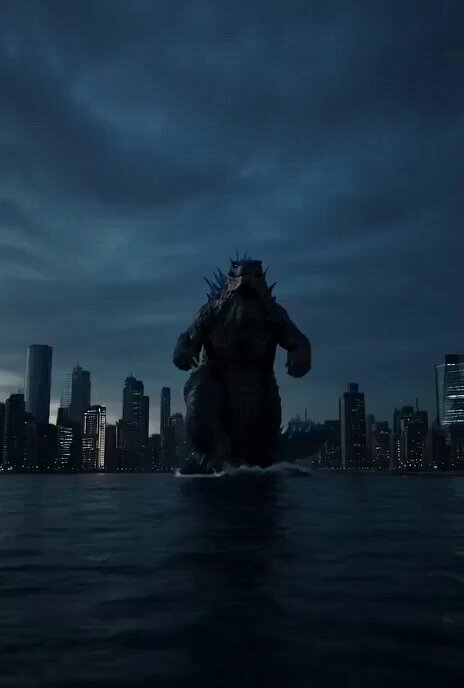 The image features a large Godzilla monster standing in the water, surrounded by tall buildings. The monster appears to be walking through the ocean with its head above the water surface. Below the monster, there are several skyscrapers that add an urban element to the scene. The caption "Godzilla Grok trailer made by @Grok imagine 1.5" suggests that this image is part of a promotional campaign for a movie or TV show featuring Godzilla as the main character.