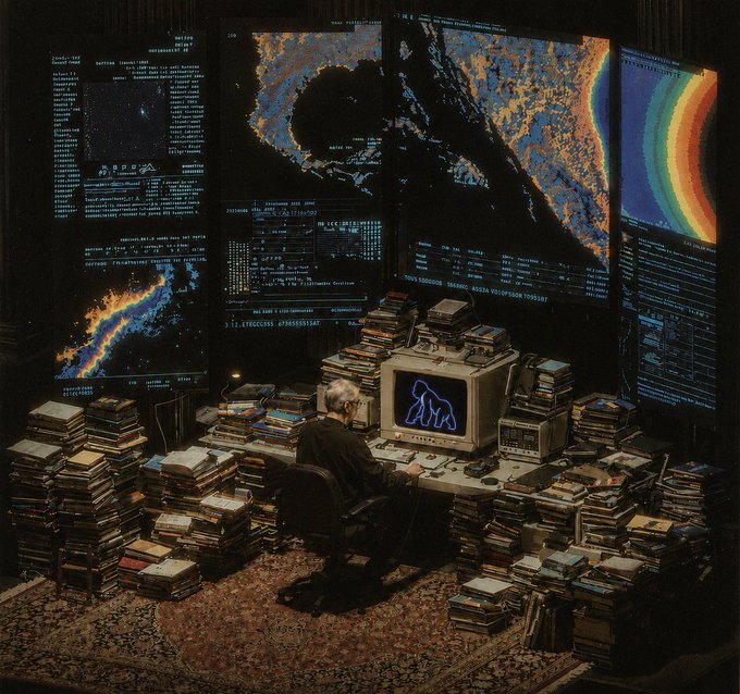 In a room filled with stacks of books and vintage computer monitors displaying complex data and a neon gorilla, a person works surrounded by information, fitting the theme of "Experience a global network. $APE".