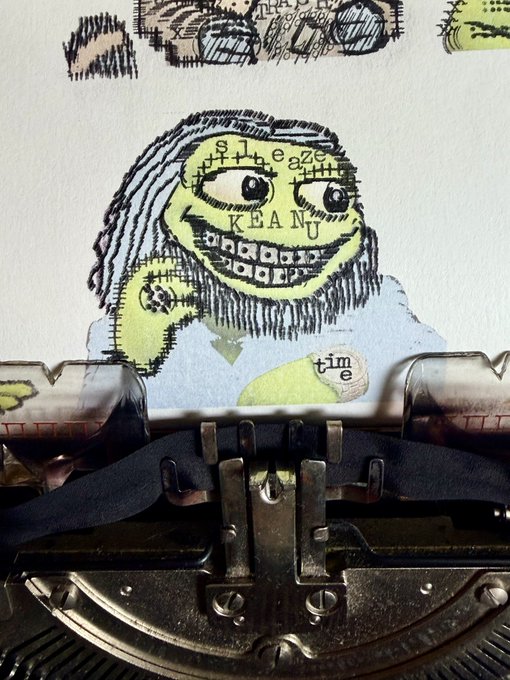 A mixed-media artwork on a typewriter featuring a stitched, green-skinned figure labeled "KEANU" with the words "squeeze" and "time" visible in the background.