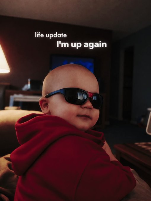 A meme image of a baby wearing oversized black sunglasses with text overlay reading 'life update / I'm up again'.