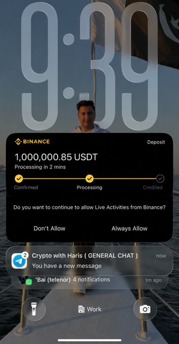 A Binance notification on an iPhone lock screen confirms a deposit of **1,000,000.85 USDT**, currently processing in 2 minutes with stages showing "Confirmed" and "Processing," alongside Telegram and WhatsApp alerts. The image relates to the post's humorous question about whether receiving a $1 million deposit would tempt someone to quit trading and enjoy life, highlighting the relatable fantasy of sudden crypto wealth.