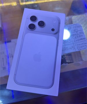 A smartphone (appears to be an iPhone) in its white retail box sits on a glass surface next to a handwritten receipt reading "IPHONE 15 PRO MAX" with a price of "225,491" and the date "01/15/24," suggesting the user successfully purchased the long-awaited device after a 4-hour effort.
